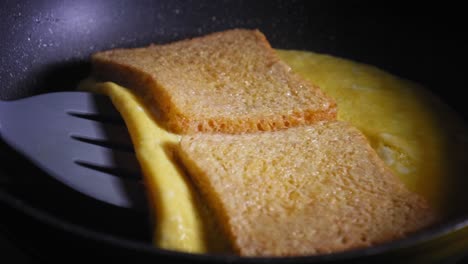 Making-egg-and-cheese-toast-in-pan-folding-it-together-and-letting-it-cook