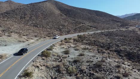 Line-of-vehicle-drives-on-highway-road-in-Palm-Desert,-California