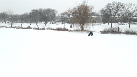 Tres-Personas-Caminando-En-El-Parque-Durante-Una-Tormenta-De-Nieve-En-Invierno