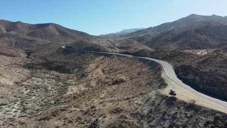 Lonely-car-stopped-on-desert-highway-side-in-California,-aerial-drone-shot