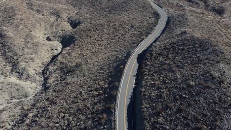 Lonely-car-drives-on-California-highway-number-74,-aerial-drone-shot