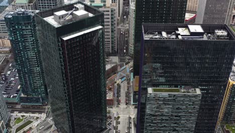 Aerial-high-above-Seattle-showcasing-how-small-the-streets-are-beneath-the-skyscrapers