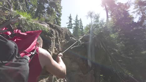 Hiker-Pulling-on-a-Rope-up-Mount-5040,-Vancouver-Island,-Canada