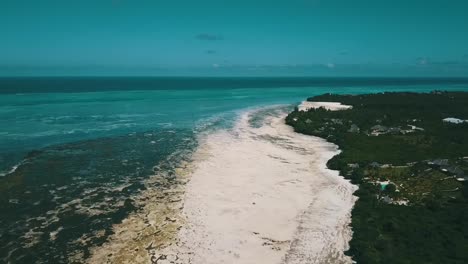 Gorgeous-verry-high-rotation-360-drone-shot-of-a-lonely-drem-beach-in-paradise-and-a-reef-at-ebb