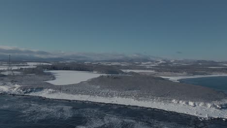 Aerial-Establishing-Shot-Of-Winter-Snow-Covered-Shore-In-Hokkaido
