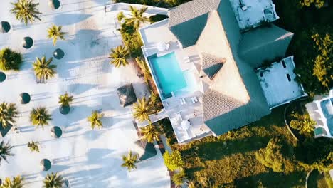 Great-rotation-360-drone-shot-from-above-a-luxury-villa-with-a-fantastic-pool-and-long-shadows