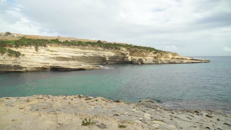 Calm-Mediterranean-Sea-Washes-the-Limestone-Shore-of-Stone-Beach-Il-Kalanka-in-Malta
