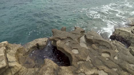 Shore-of-Stone-Beach-Il-Kalanka-in-Malta-with-Clear-Water-of-Mediterranean-Sea