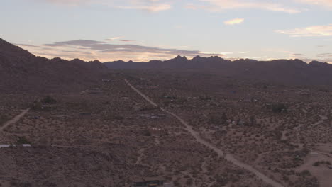 Aerial-boom-up-over-beautiful-desert-landscape-in-Joshua-Tree,-California-at-sunrise