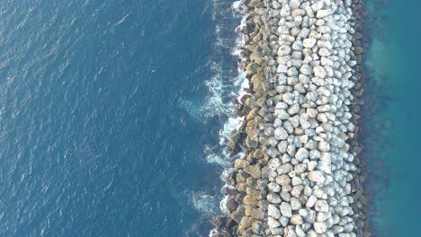 Redondo-Beach-Rock-Wall-|-Clear-Blue-Ocean-|-Day-Time-|-Overhead-Rising-Shot