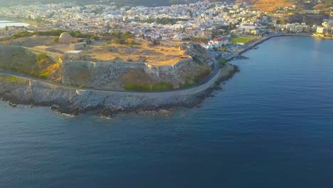 Flying-a-drone-away-from-Fortezza-Rethymno-over-the-Mediterranean-sea-in-Crete-Greece