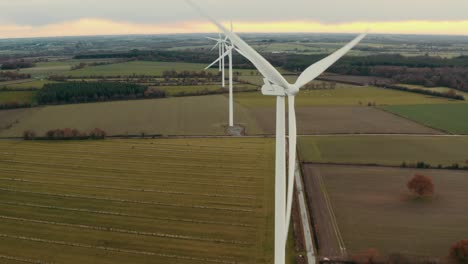 Beautiful-spin-drone-movement-of-wind-farm-white-wind-turbine-spinning,-clean-energy-renewable-alternative