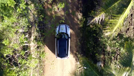 Top-View-Of-White-Mini-Cooper-Driving-In-The-Dirt-Road-At-Summer