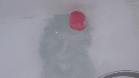 Dropping-sponge-in-to-bath-foam
