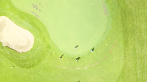 Drone-footage-of-golfer-on-putter-green