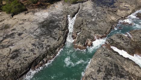 Costa-Rica,-Rocky-Stone-Coast-with-waves-splashing-aginst-the-stones,-Dji-Drone-Shot