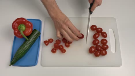 Hombre-Cortando-Tomates-Ciruela-Con-Cuchillo