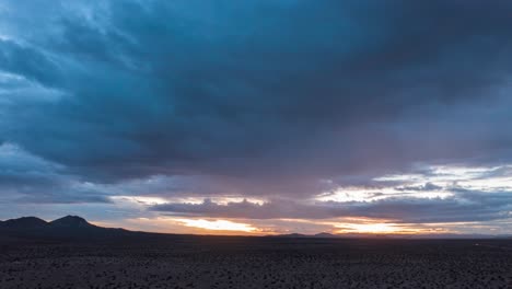 Colorful-sunset-view-of-the-Mojave-Desert's-wilderness-terrain---aerial-hyper-lapse