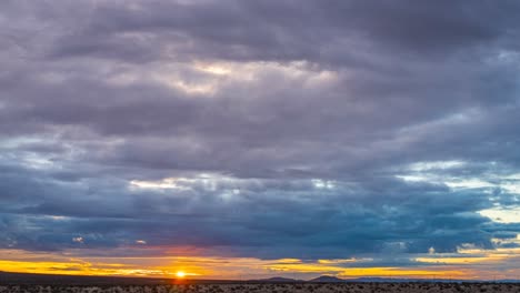 Golden-sunrise-dawns-over-the-arid-landscape-of-the-Mojave-Desert-basin---wide-angle-time-lapse