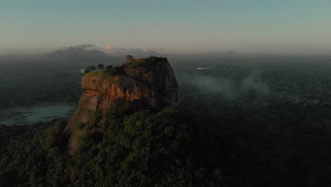 AERIAL:-Drone-view-Sunrise-at-the-Lion-Rock-in-Sigiriya,-Dambulla-SRI-LANKA