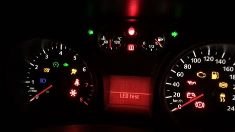 Flickering-and-flashing-warning-LED-light-on-a-dashboard-panel-on-car-which-broke-down-at-night
