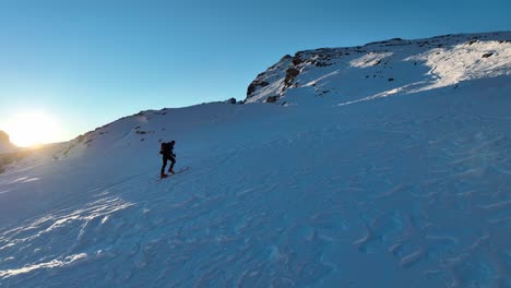 Male-person-ski-touring-during-sunrise-in-the-Dolomites
