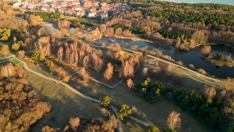 gdańsk-przymorze-poland,-drone-fly-above-the-city-and-revealing-amazing-landscape-of-the-countryside-with-green-area-during-Golden-hours