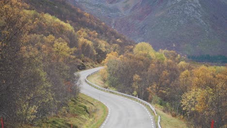 A-narrow-road-goes-through-the-colorful-autumn-valley