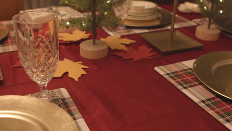 Slide-over-festive-holiday-table-towards-gold-plate-place-setting