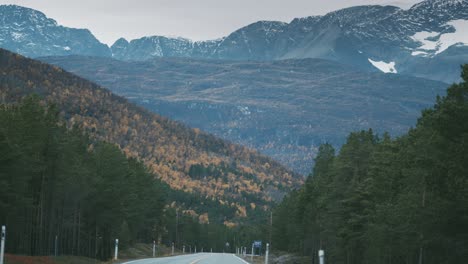 The-two-lane-rural-road-runs-through-the-autumn-valley