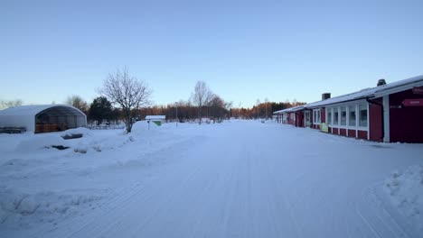 Slight-movement-toward-the-red,-snow-covered-houses