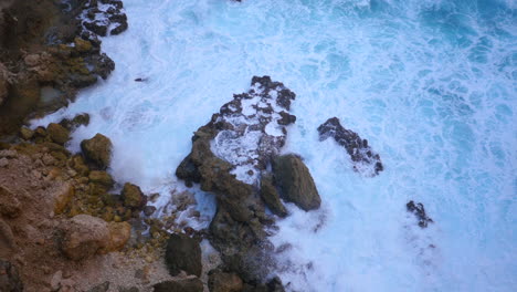 View-from-top-of-a-cliff-down-to-crashing-blue-waves