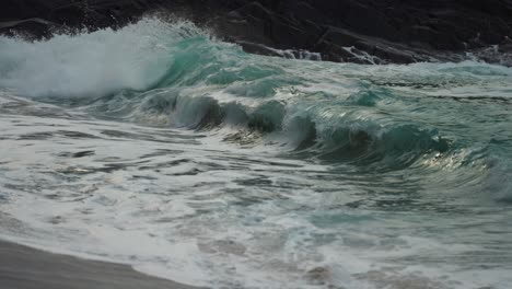 Waves-crashing-on-the-rocky-shore.-Slow-motion,-close-up