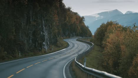 The-two-lane-mountain-road-runs-through-the-autumn-landscape