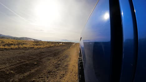 Looking-back-along-the-side-of-a-truck-while-driving-on-an-off-road-trail