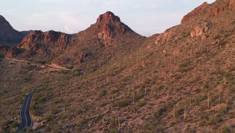 Remote-Single-Highway-Curves-Through-American-Desert-Landscape-at-Golden-Hour-Sunset