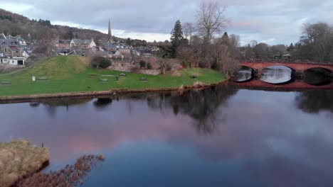 Aerial-footage---flying-over-a-river-and-a-small-town-in-Scottish-Highlands