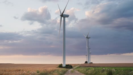 A-row-of-wind-turbines-in-the-wheat-fields-on-the-sunset