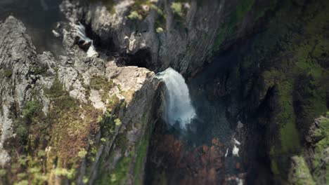 Aerial-view-of-the-waterfall-cascading-through-the-deep-rocky-canyon