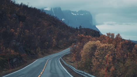 The-narrow-two-lane-road-runs-through-the-autumn-valley