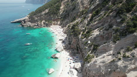 Aerial-drone-video-of-tropical-paradise-turquoise-beach-in-the-mediterranean,-Sardinia,-Cala-Gonone