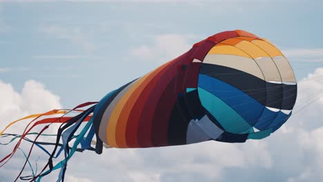 A-close-up-shot-of-a-parafoil-kite-floating-in-the-air-at-the-Romo-kite-festival