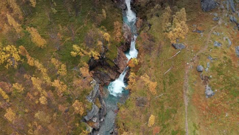Aerial-view-of-the-wild-river-cascading-through-the-narrow-canyon