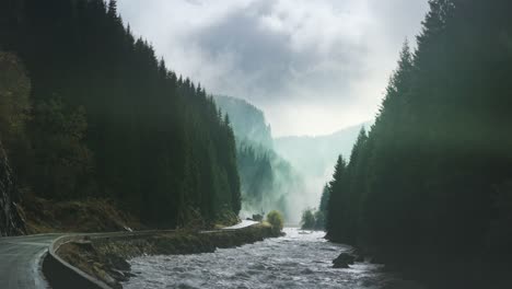 A-wild-mountain-river-rushes-along-the-narrow-road