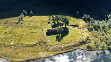 A-tilt-shift-video-of-a-traditional-sod-roof-house-on-the-river-bank