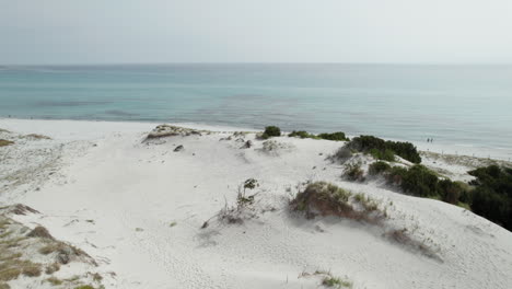 Aerial-drone-video-of-sand-dunes-on-the-sea-near-the-beach-in-the-mediterranean,-Sardinia,-Capo-Comino