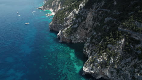 Aerial-drone-video-of-blue-paradise-sea-cliffs-in-the-mediterranean,-Sardinia,-Cala-Gonone