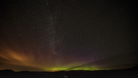 Mesmerizing-night-day-timelapse-of-the-Milky-Way-and-northern-lights-in-the-dark-night-sky-above-the-valley