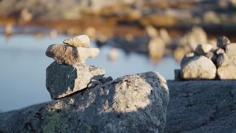 A-close-up-shot-of-the-small-stone-cairns-on-the-top-of-the-big-boulder