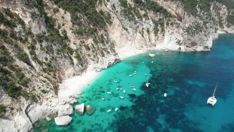 Aerial-drone-video-of-tropical-paradise-beach-in-summer-in-the-mediterranean,-Cala-Gabbiani,-Sardinia,-Italy